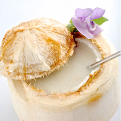 Fresh Cut coconut smoothie with a metal straw